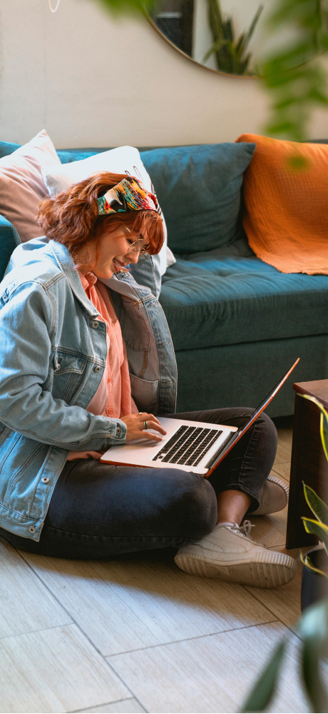 Female student sitting on the floor with a laptop