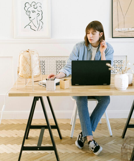 Female student sitting at a desk in front of a laptop