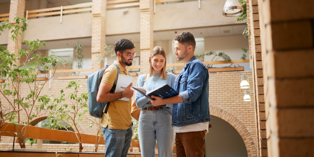 Three students reviewing notes